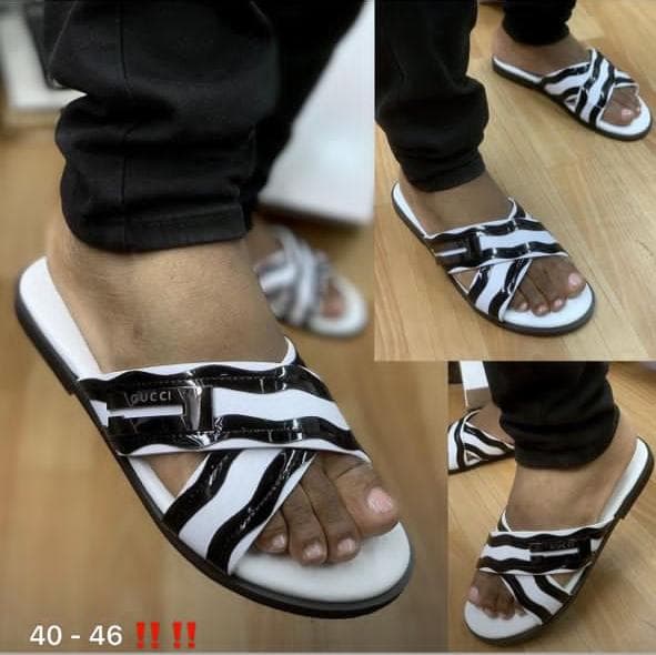 Black and white zebra print Gucci slides worn with black trousers, collage of multiple angles.