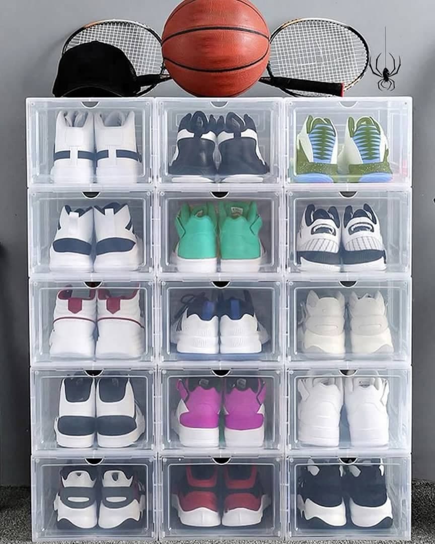 Stack of transparent acrylic shoe boxes arranged in a grid, each holding a different pair of sneakers.