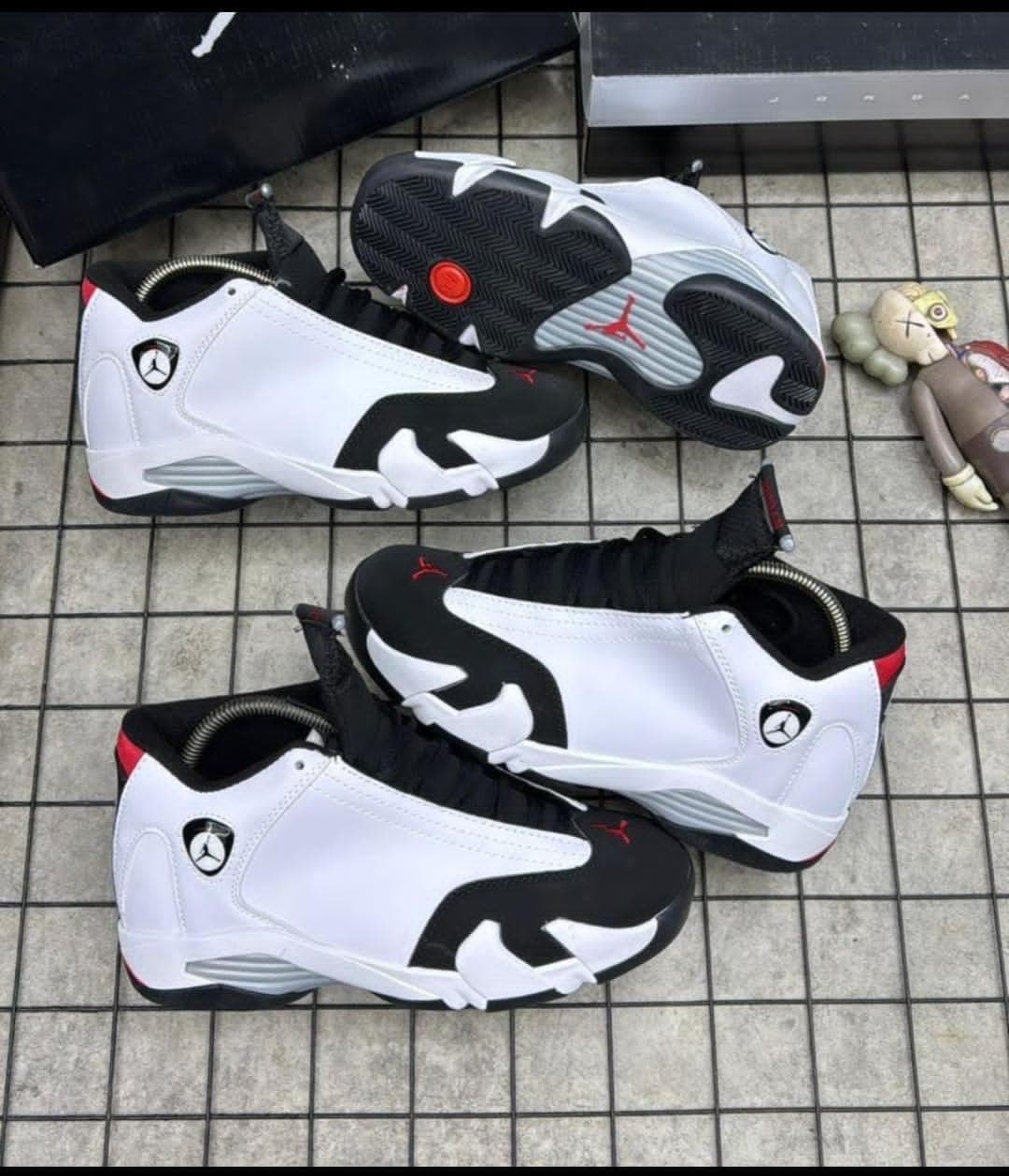 Air Jordan 6 sneakers in white black and red shown from multiple angles on tiled floor with accessories.