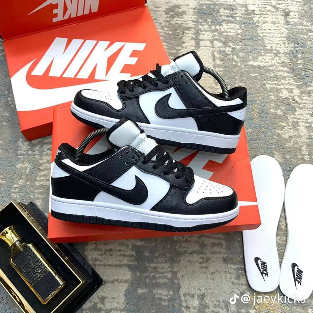 Nike Dunk Low Panda in black and white displayed on orange Nike box with insoles.