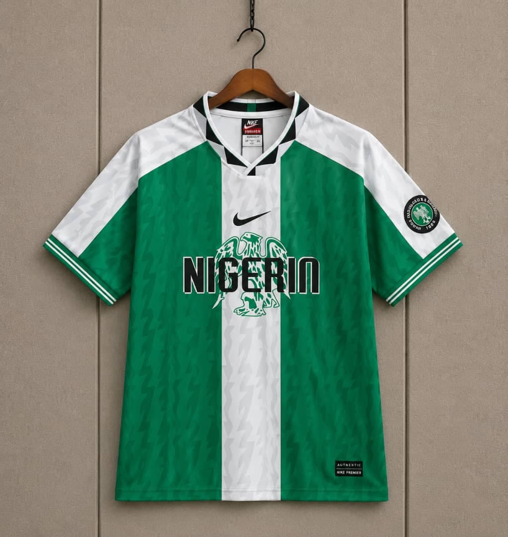 Green and white Nike Nigeria Super Eagles jersey on hanger.
