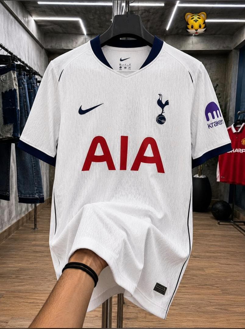 White Nike Tottenham Hotspur football jersey with red AIA logo on hanger.