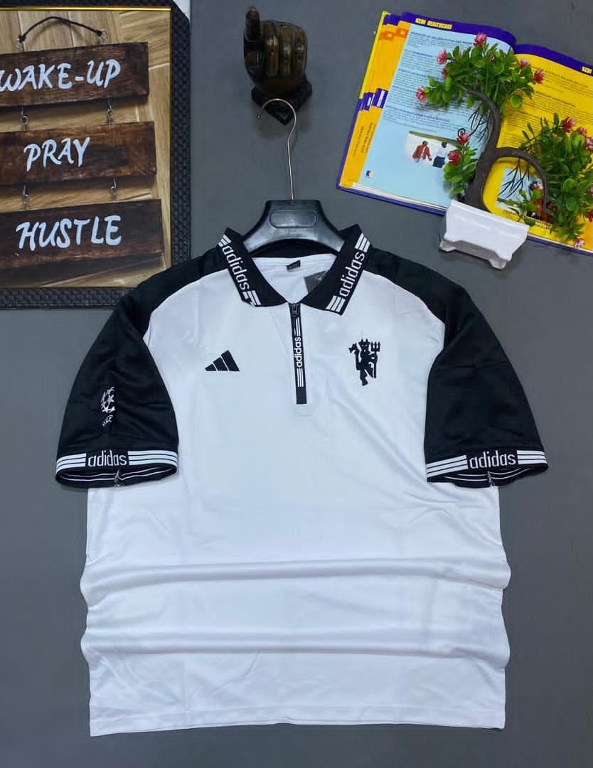 White and black Adidas Manchester United polo jersey with devil crest.
