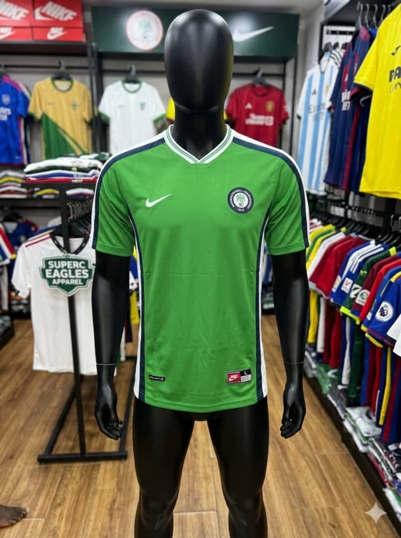 Green Nike Super Eagles jersey on mannequin in apparel store.