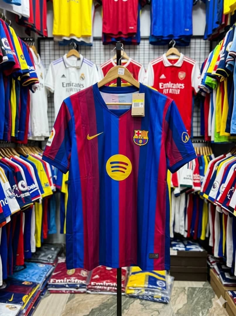 Striped blue and red Nike FC Barcelona jersey on stand in store.
