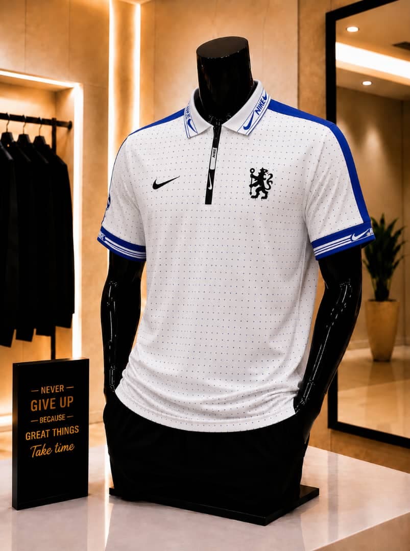 White Nike Chelsea polo jersey on mannequin in retail store.