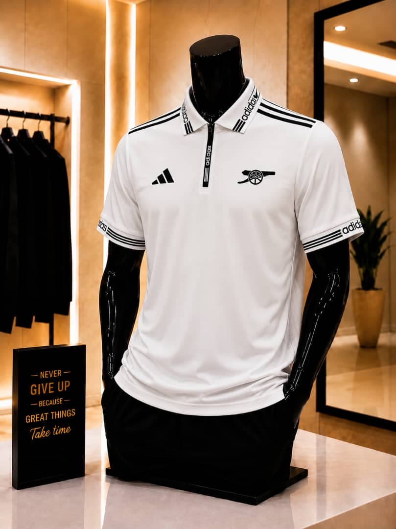 White Arsenal Adidas polo jersey on mannequin with black accents.