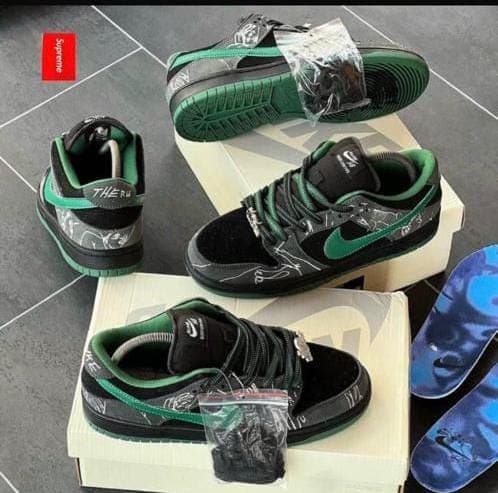 Nike Dunk Low Supreme sneakers in black green with packaging and insoles.