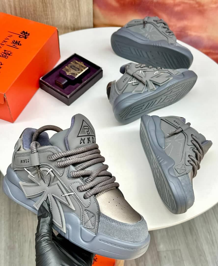 Multiple views of gray chunky high-top sneakers with cross motifs and accessories.