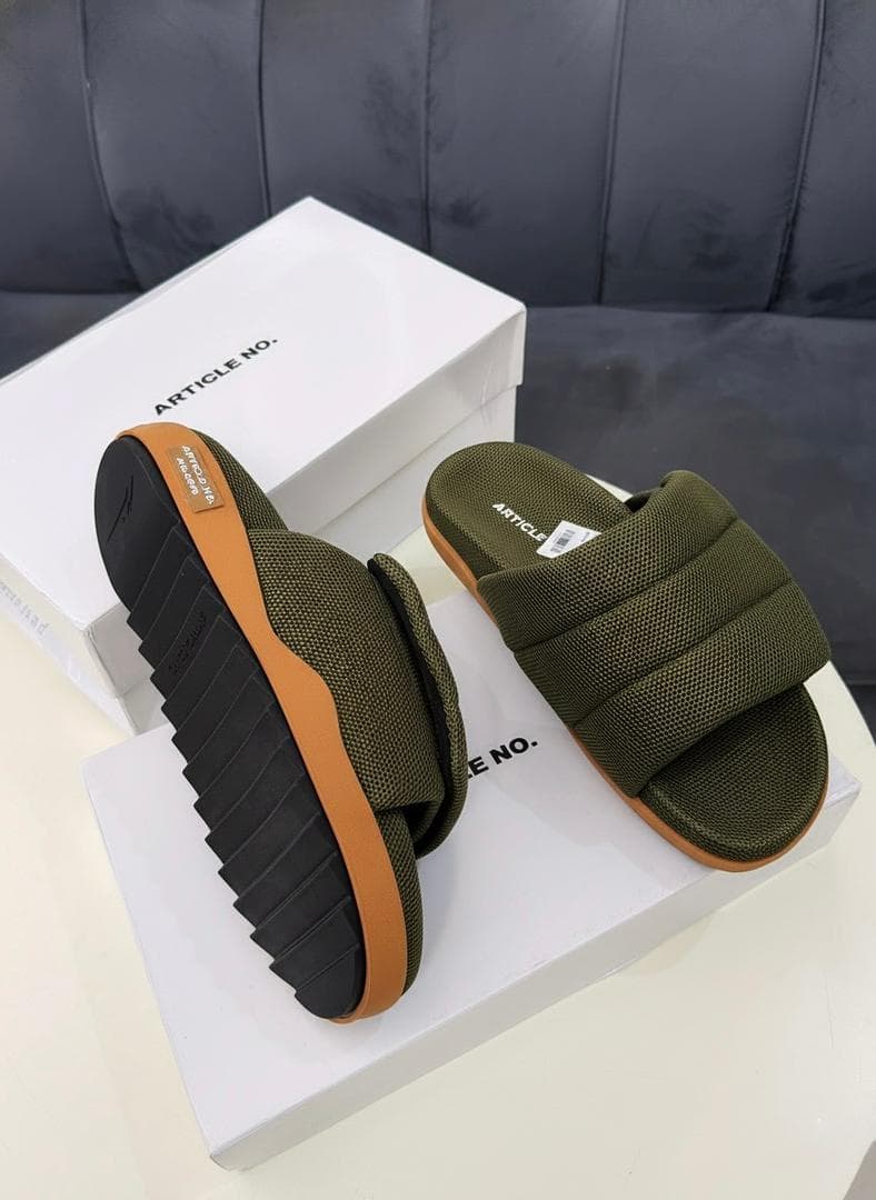 Olive green mesh platform slides with black and tan sole on white box.