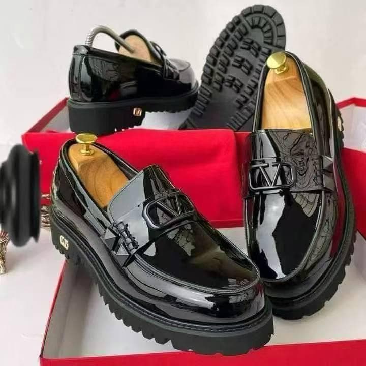 Black Valentino platform loafers shown from multiple angles inside red box with gold hardware.