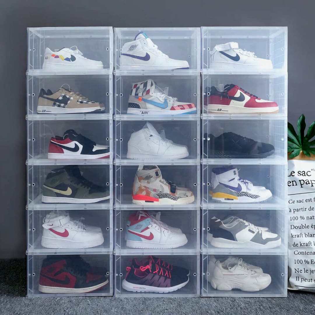 Grid of stacked transparent acrylic shoe boxes each containing a different pair of sneakers.