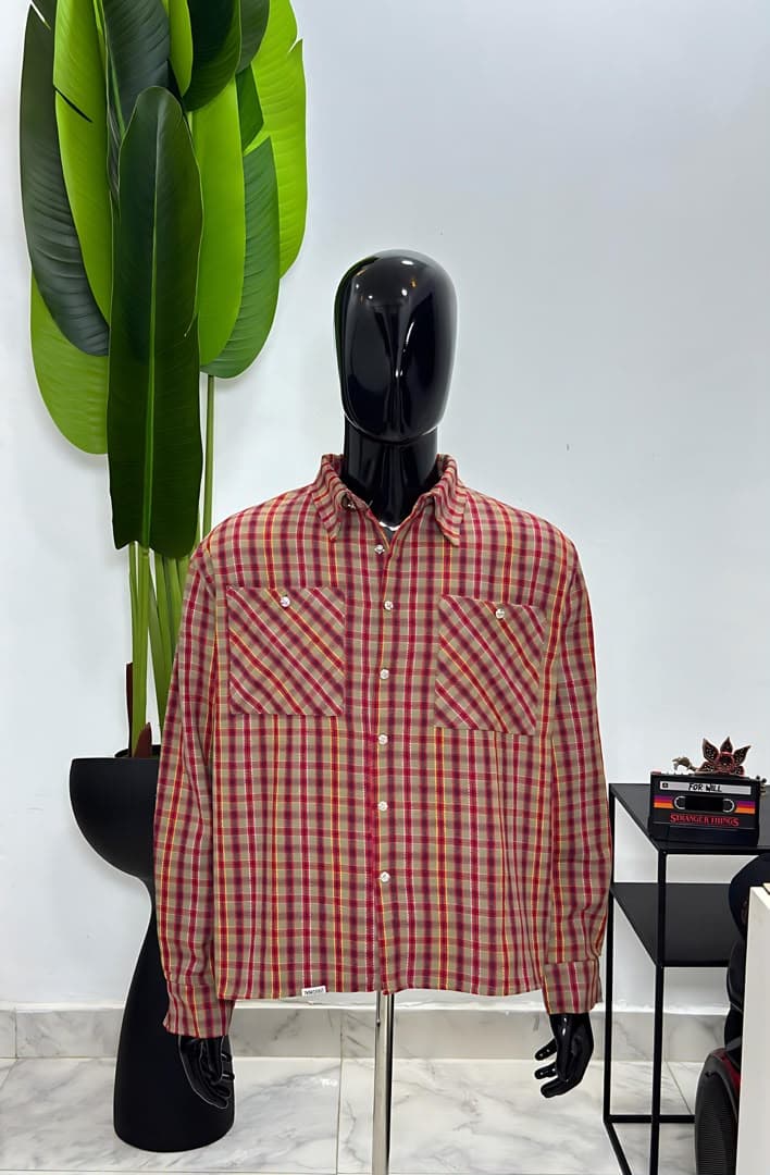 Mannequin wearing red plaid long-sleeve button-up shirt jacket with chest pockets.