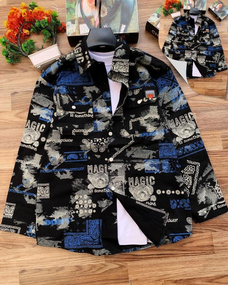 Black denim jacket with blue bandana and MAGIC prints laid flat on wooden floor.