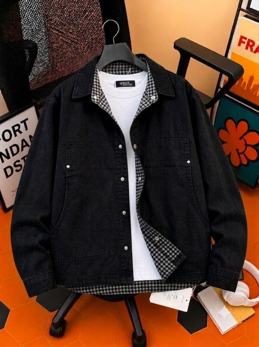 Black denim jacket with checkered inner lining and collar over white t-shirt.