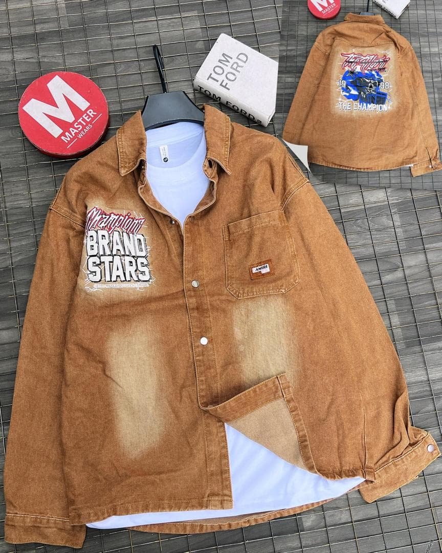 Brown graphic denim jacket with front and back prints, button front and chest pocket shown over white tee.