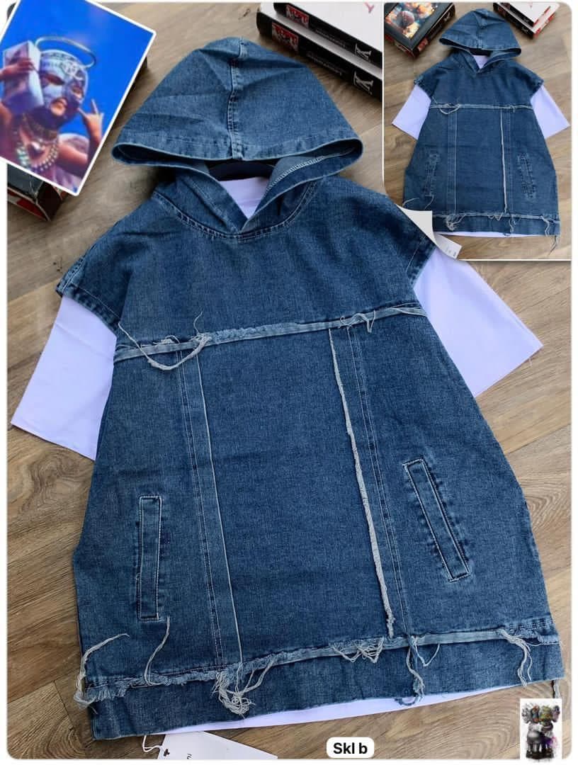 Blue denim sleeveless hooded vest with frayed edges, pockets and raw hems layered over white tee.