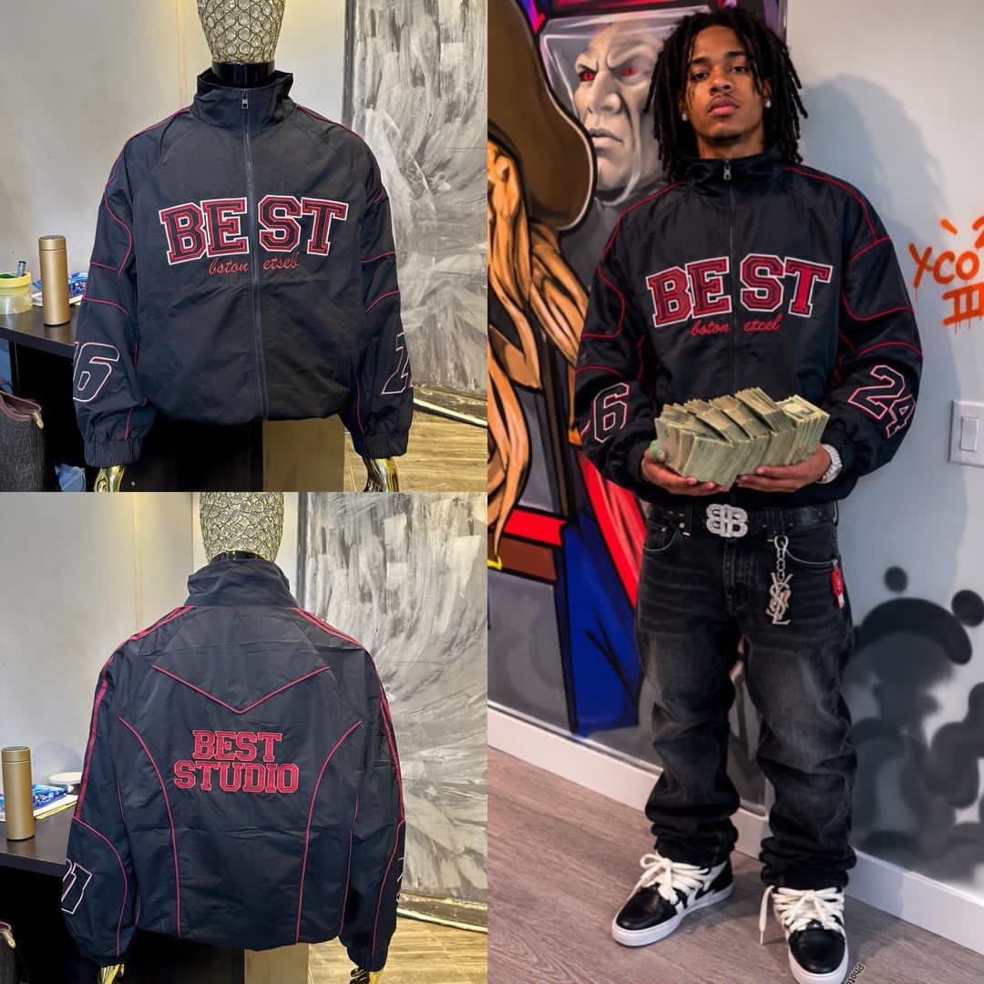 Black embroidered zip-up jacket with red accents shown on mannequin front, back, and worn by model.