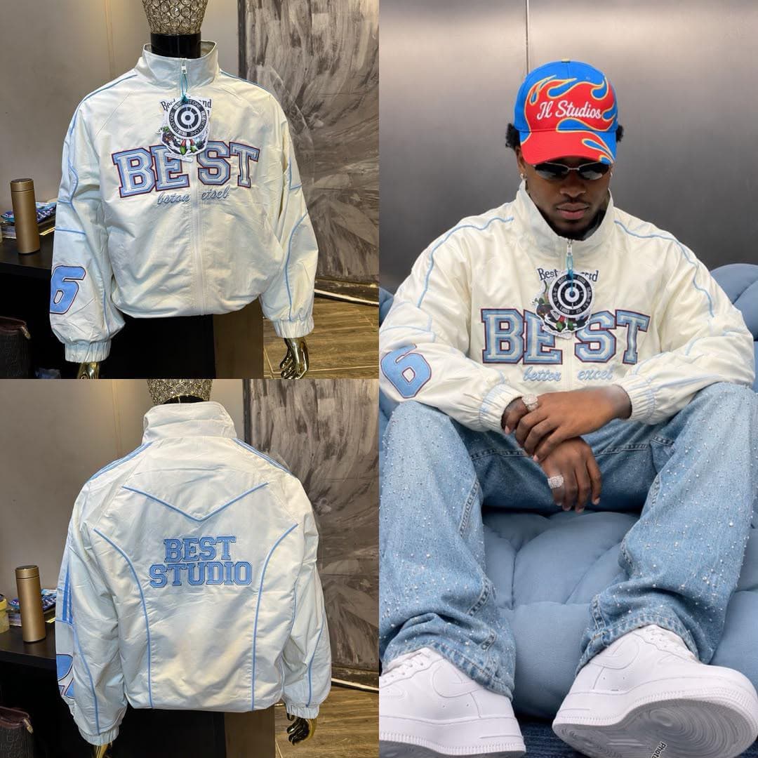 White embroidered zip-up jacket with blue accents shown on mannequin front, back, and worn by model.