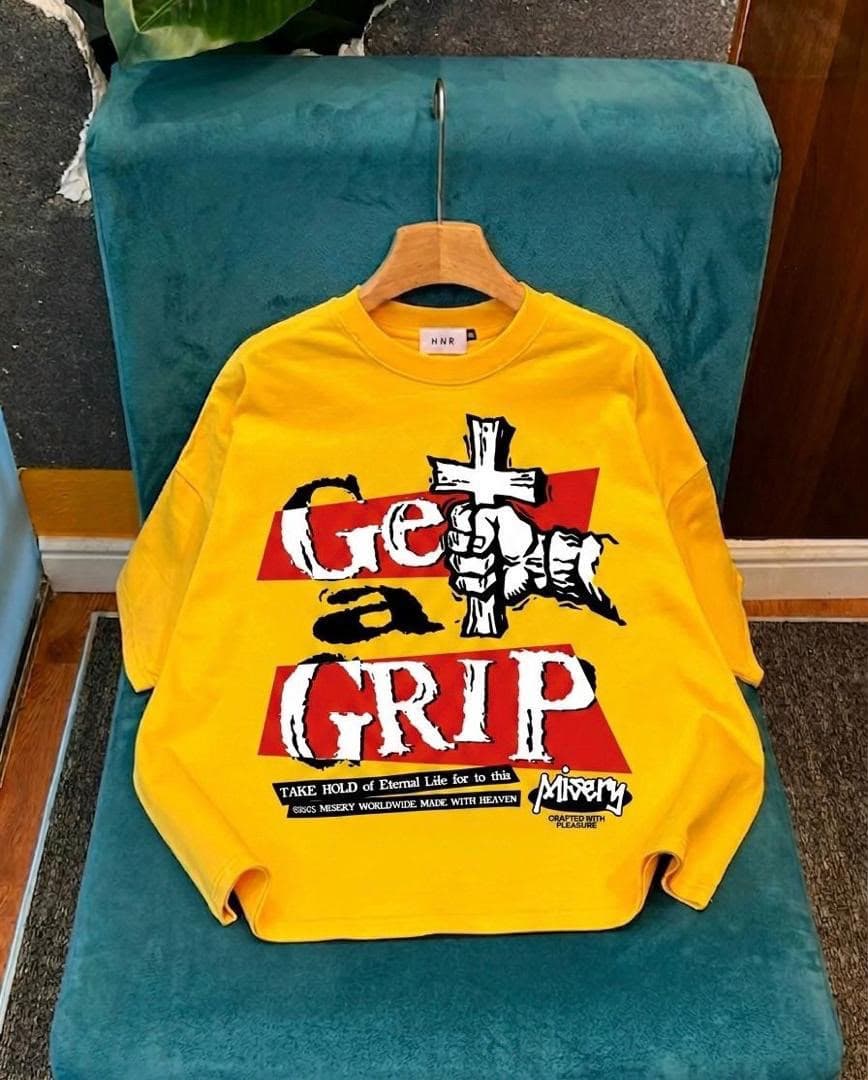 Yellow long sleeve tee with Get a Grip fist and cross graphic.