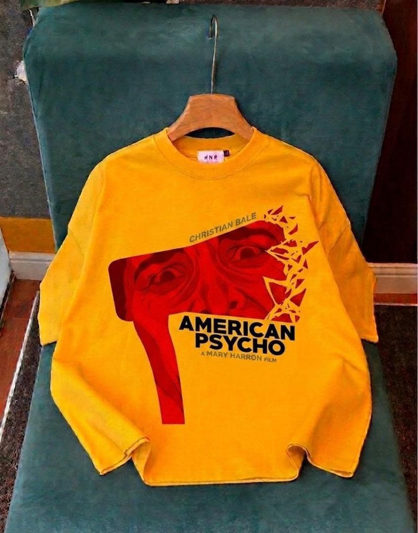 Yellow crop tee with red American Psycho face graphic and movie text.
