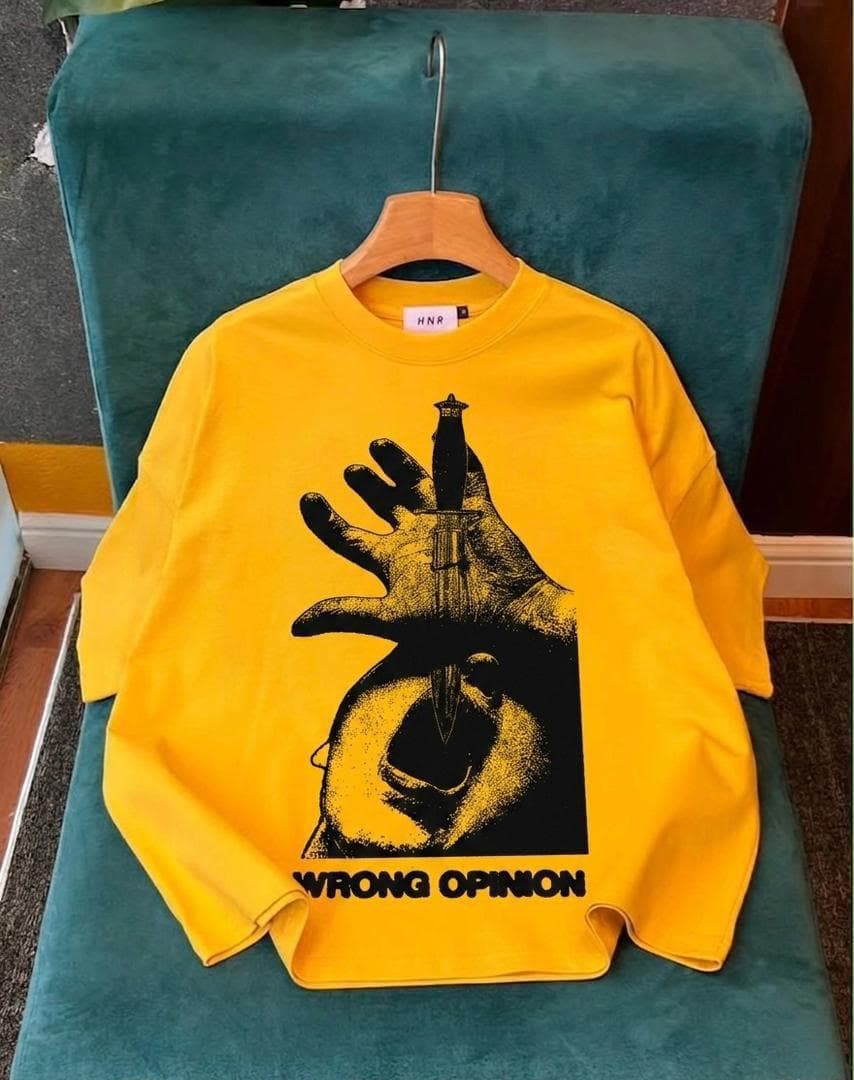Yellow crop tee with hand holding dagger graphic and WRONG OPINION text.