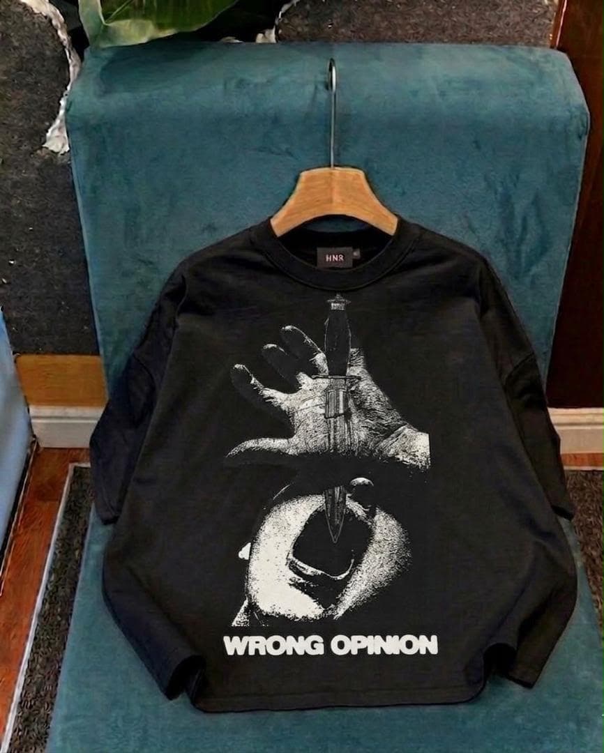 Black crop tee with hand holding dagger graphic and WRONG OPINION text.