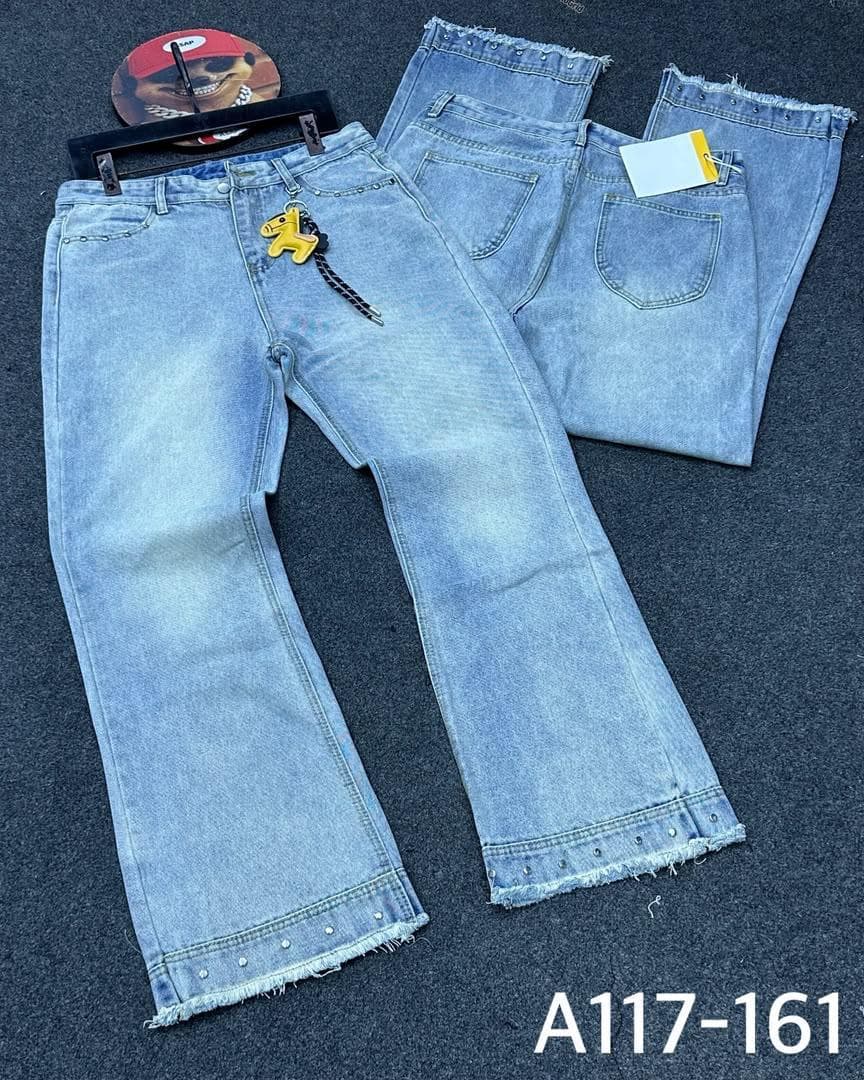 Light blue baggy jeans with frayed studded hems keychain and folded pair with tag.