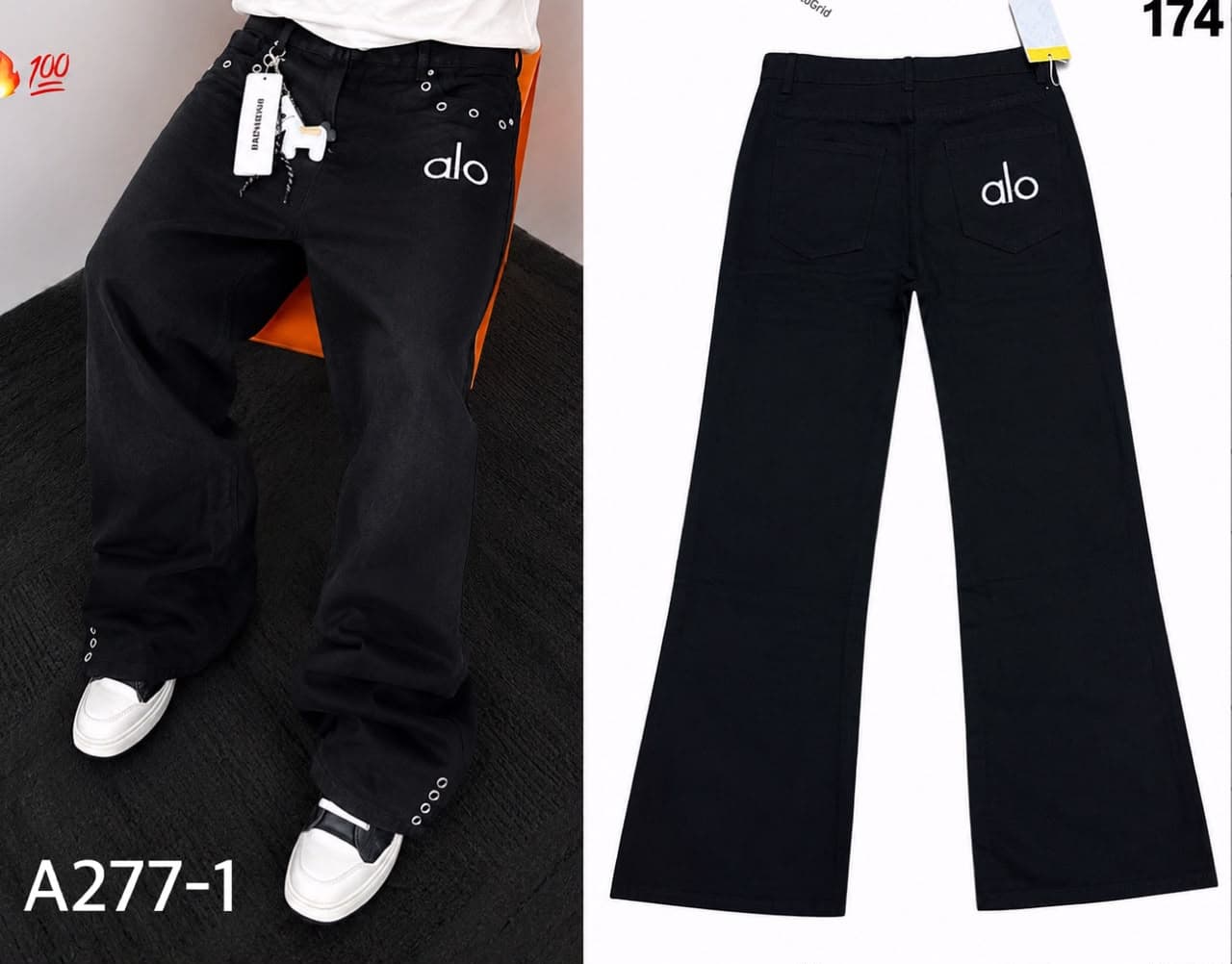 Model wearing black baggy jeans with alo logo and chain detail, with back view.