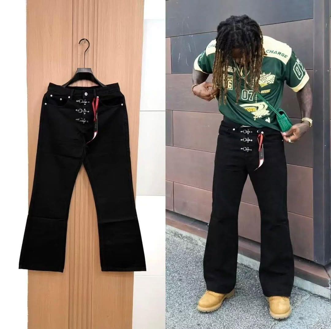 Black baggy jeans with cross details shown in flat lay and on male model with dreadlocks.