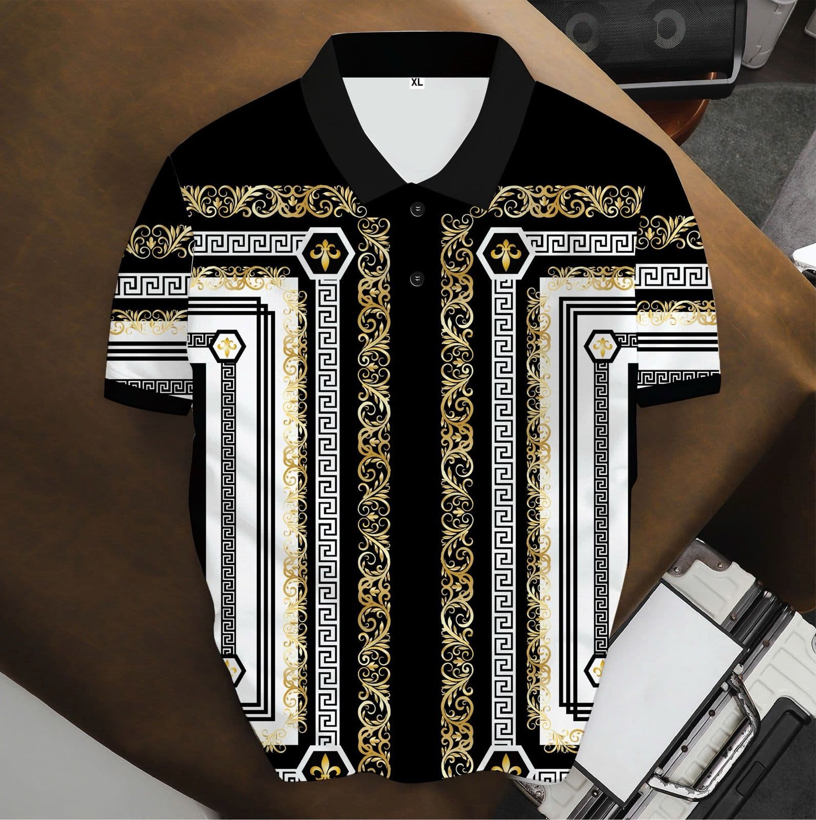 Black polo shirt with gold white ornate baroque and Greek key patterns.