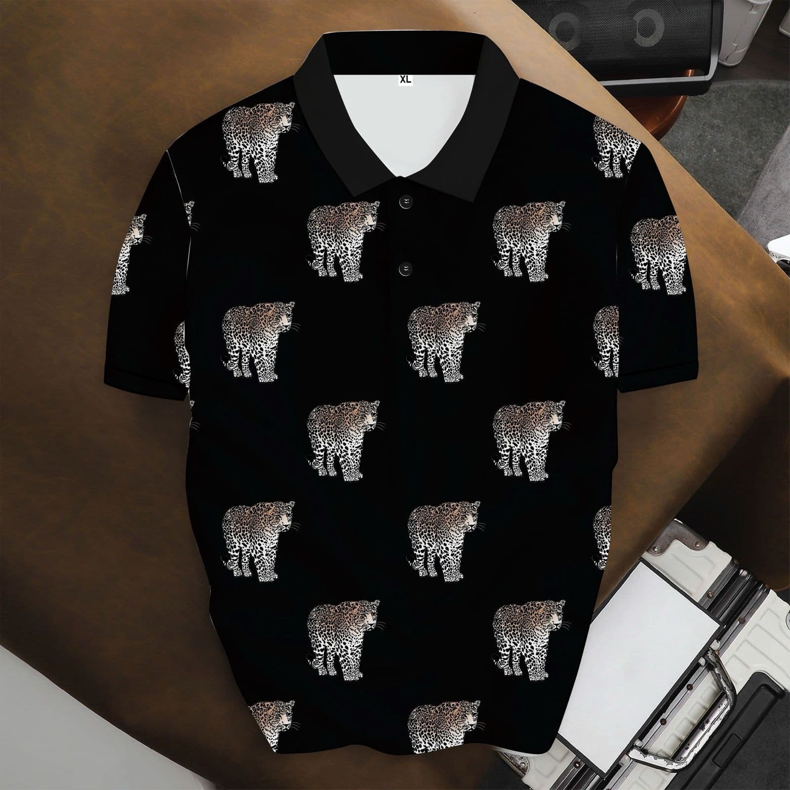 Black polo shirt with repeating leopard print pattern.