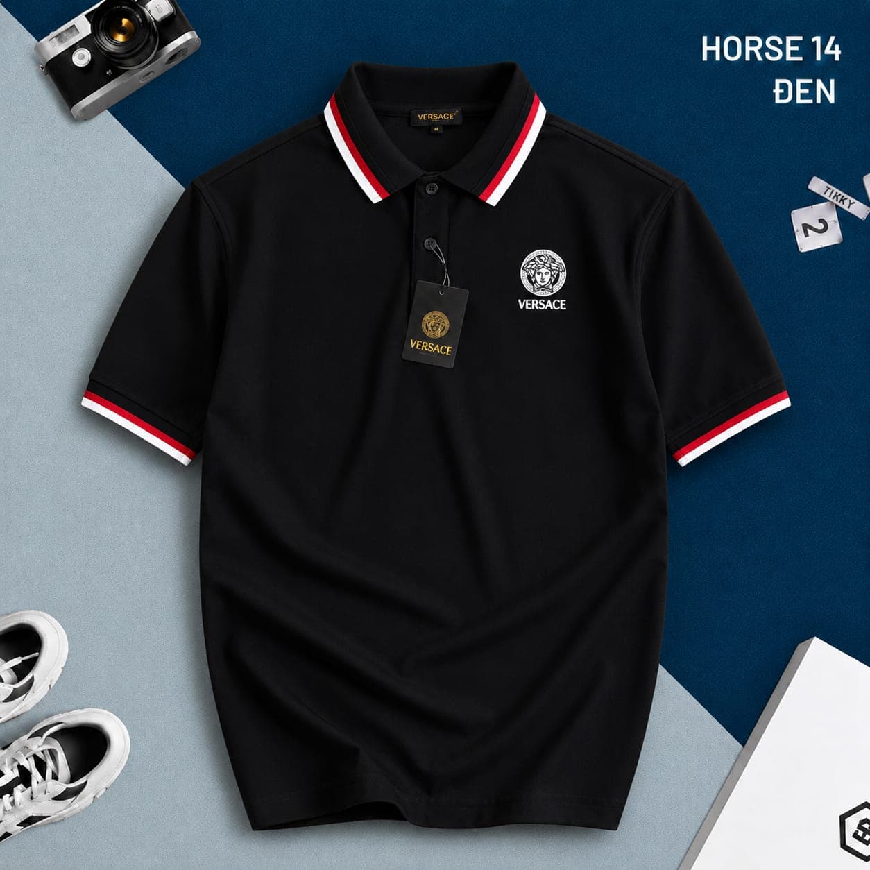 Black Versace polo shirt with red and white trim and Medusa logo on chest.