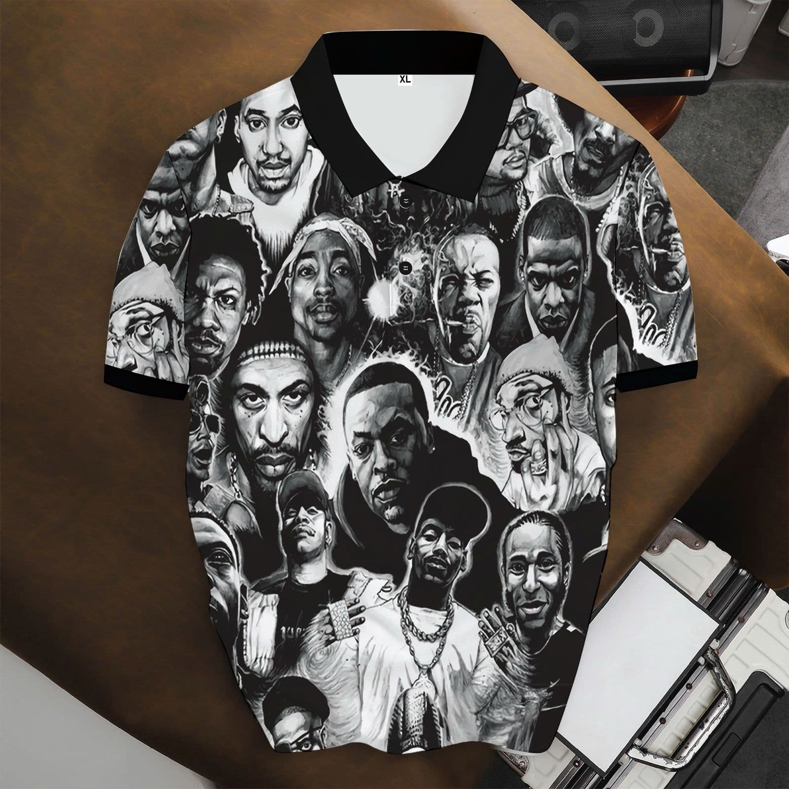 Black polo shirt with all-over black and white hip hop artists portrait print.