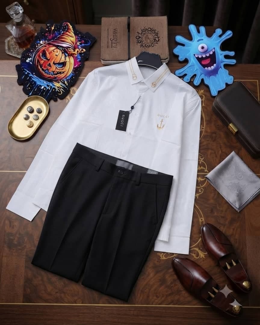 White long-sleeve Gucci anchor shirt paired with black trousers, styled with brown loafers and accessories on wooden table.