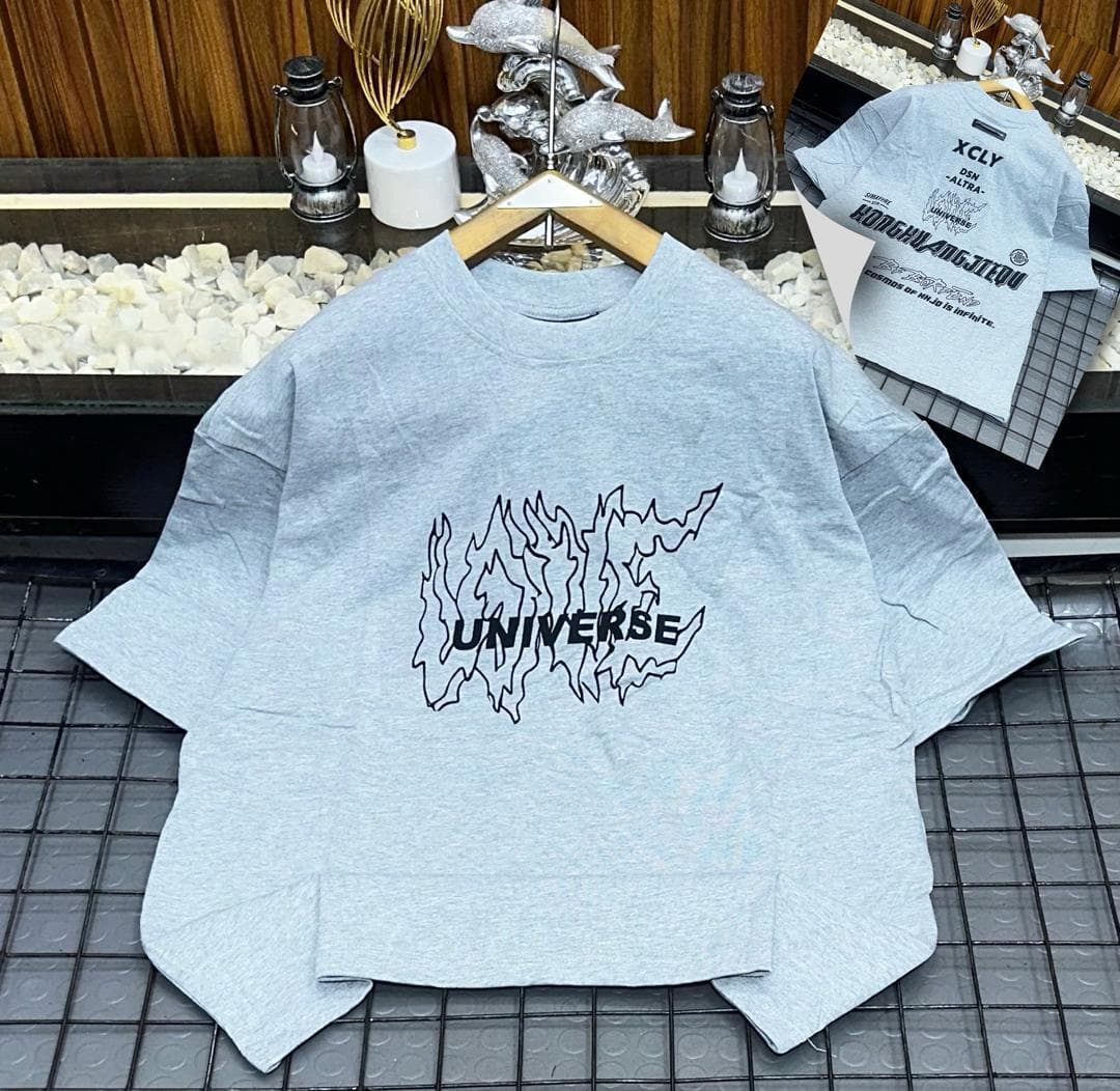 Light gray oversized t-shirt with black universe and flame outline graphic with back inset.