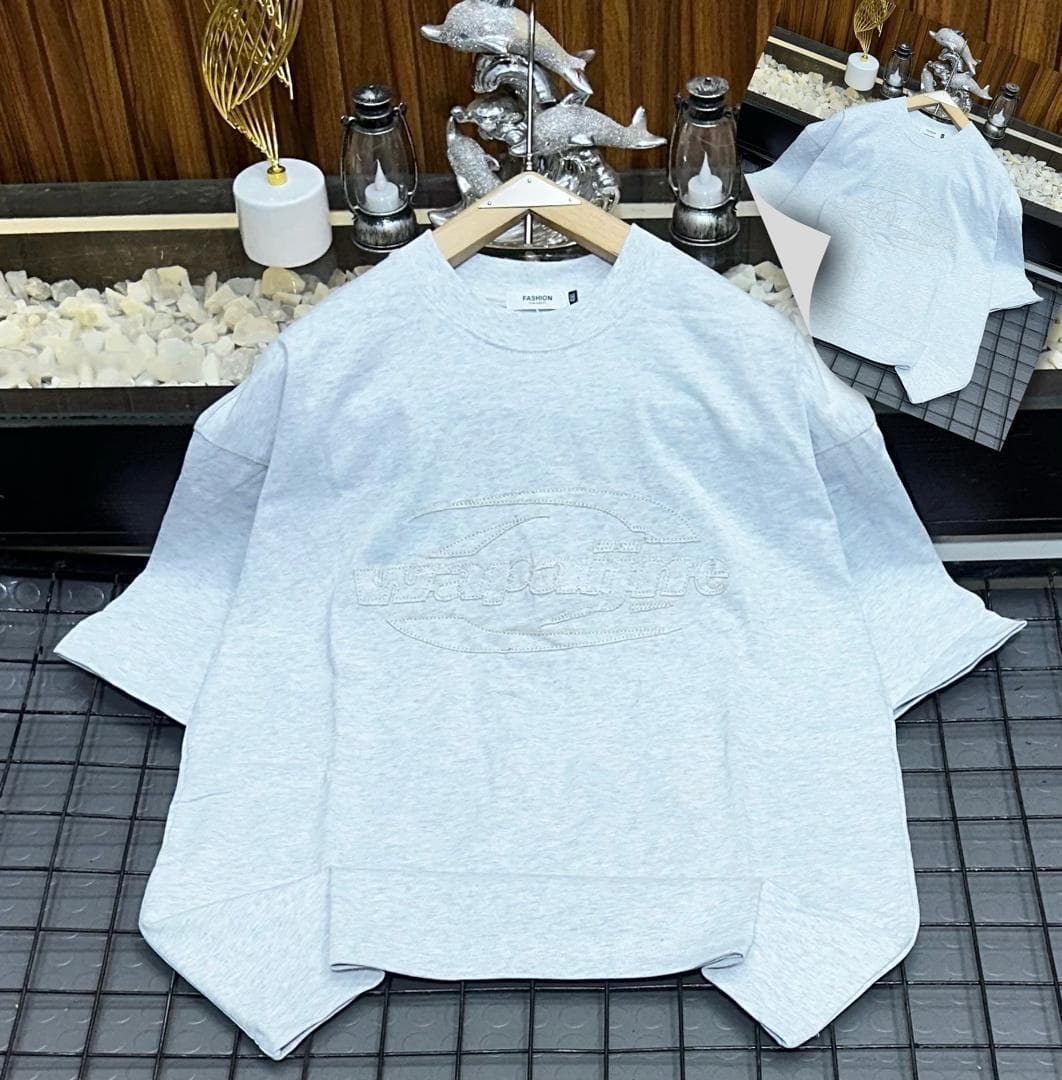 Light gray oversized t-shirt with white embroidered wayoflife oval logo on grid with inset.