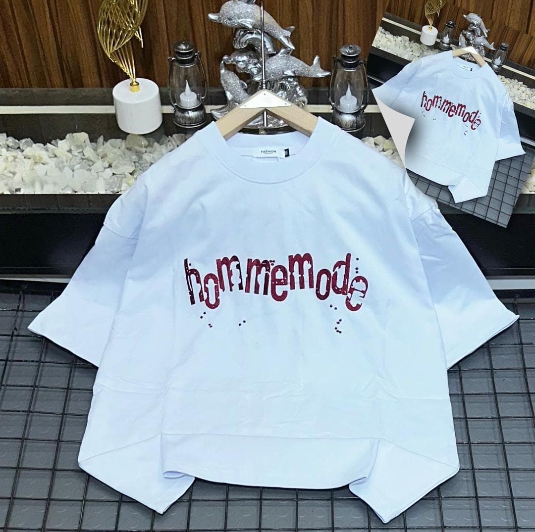 White oversized t-shirt with red hommemode dripping text print on grid background with inset.