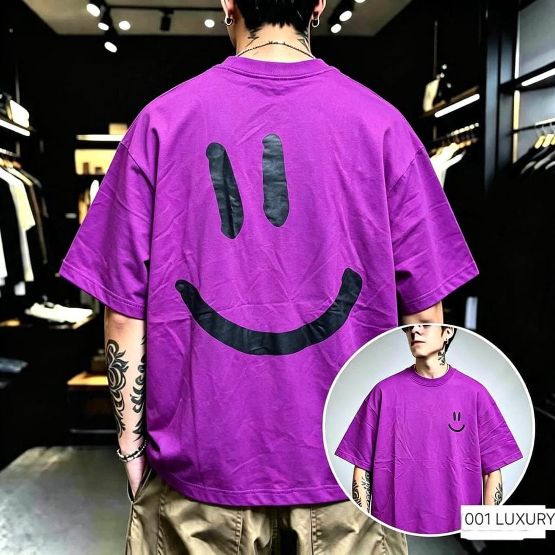 Back view of purple oversized t-shirt with large black smiley face print and inset front with small smiley.
