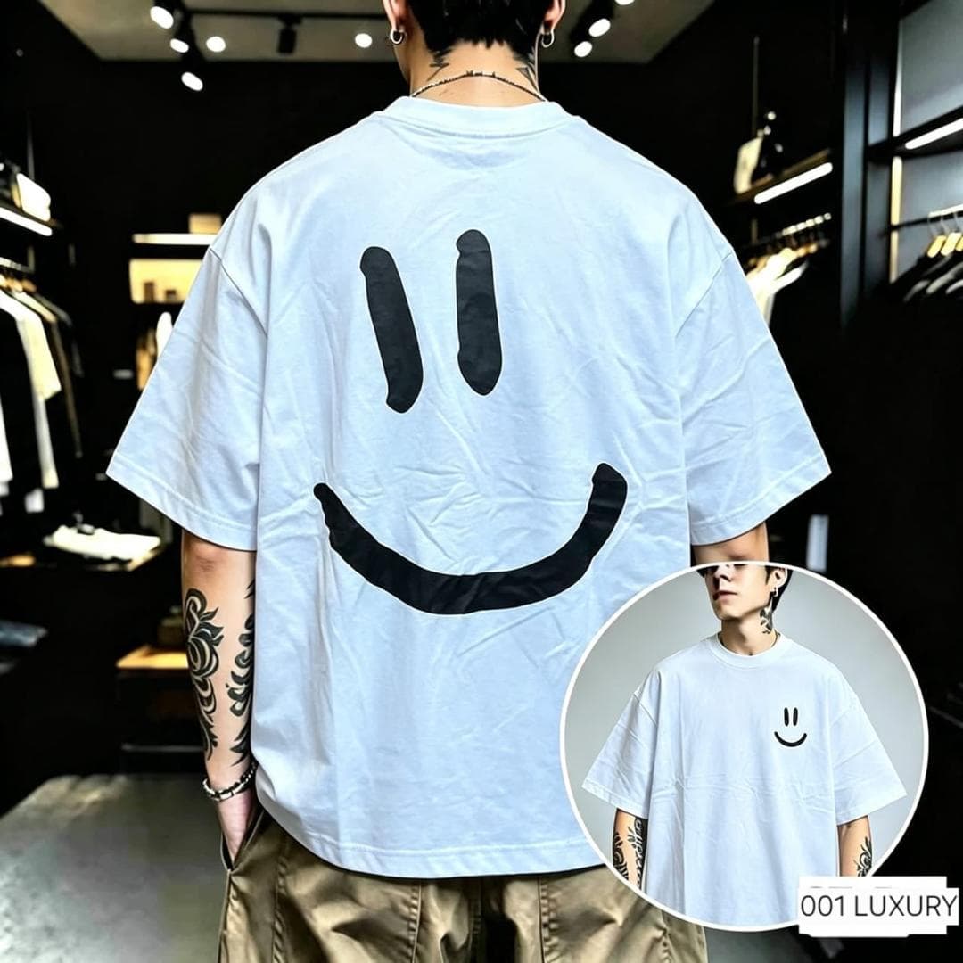 Back view of light blue oversized t-shirt with large black smiley face print and inset front with small smiley.