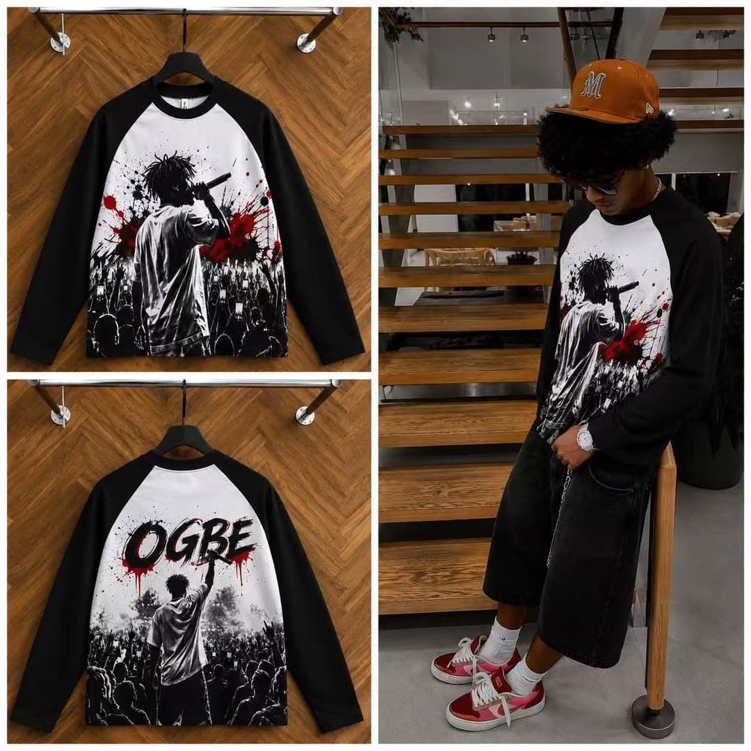 Black raglan long sleeve t-shirt with performer graphic on front and OGBE print on back, shown on hanger and model.