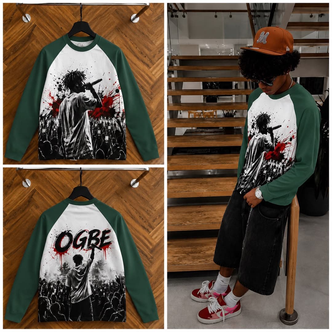 Green raglan long sleeve t-shirt with performer graphic on front and OGBE print on back, shown on hanger and model.