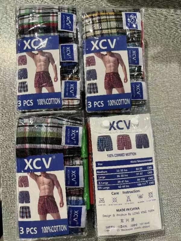 XCV 3 PCS 100% cotton boxer packs in multiple plaid and striped designs with model images and size chart.