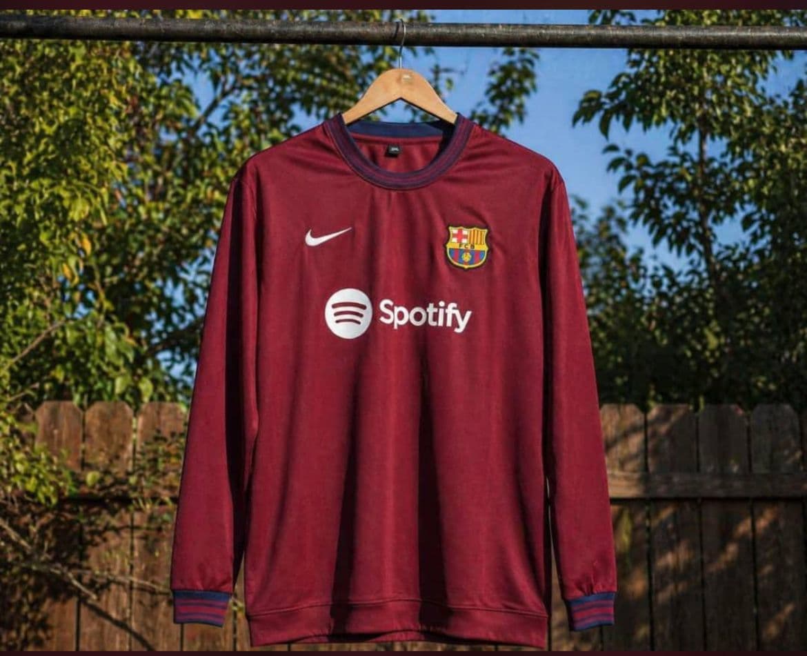 Maroon Barcelona long sleeve jersey with Spotify logo and blue striped trim.