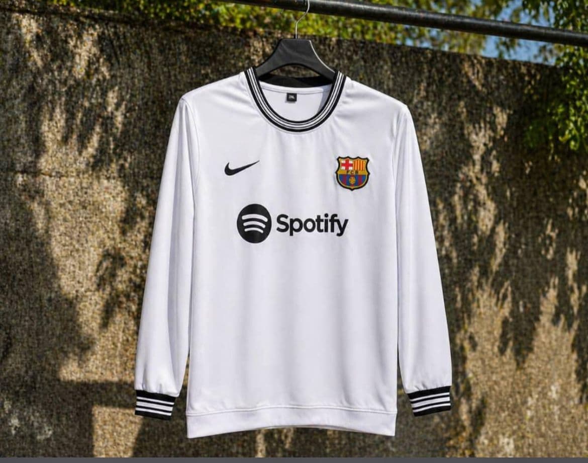 White Barcelona long sleeve jersey with Spotify logo and black trim.