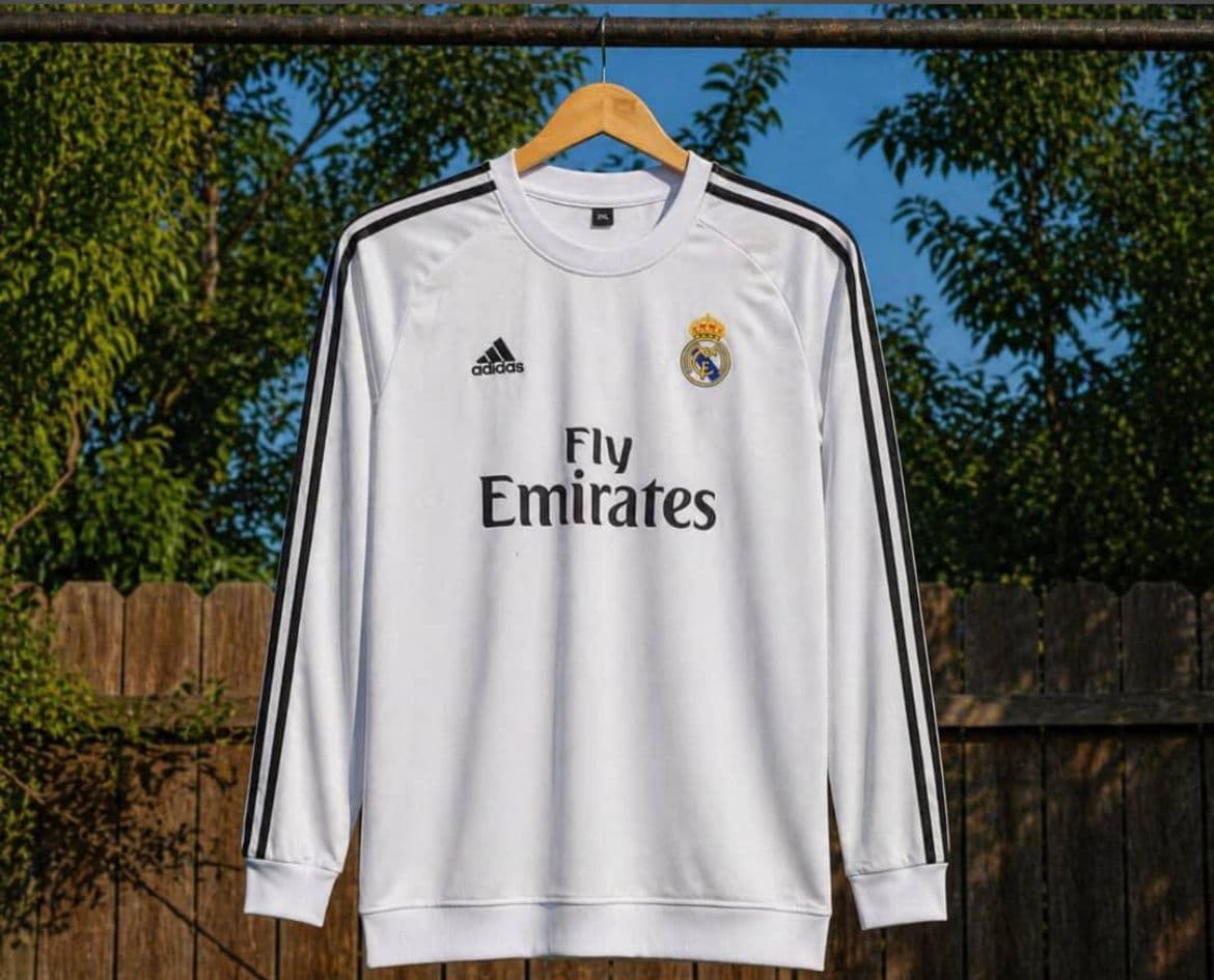 White Real Madrid long sleeve jersey with black stripes and Fly Emirates sponsor.