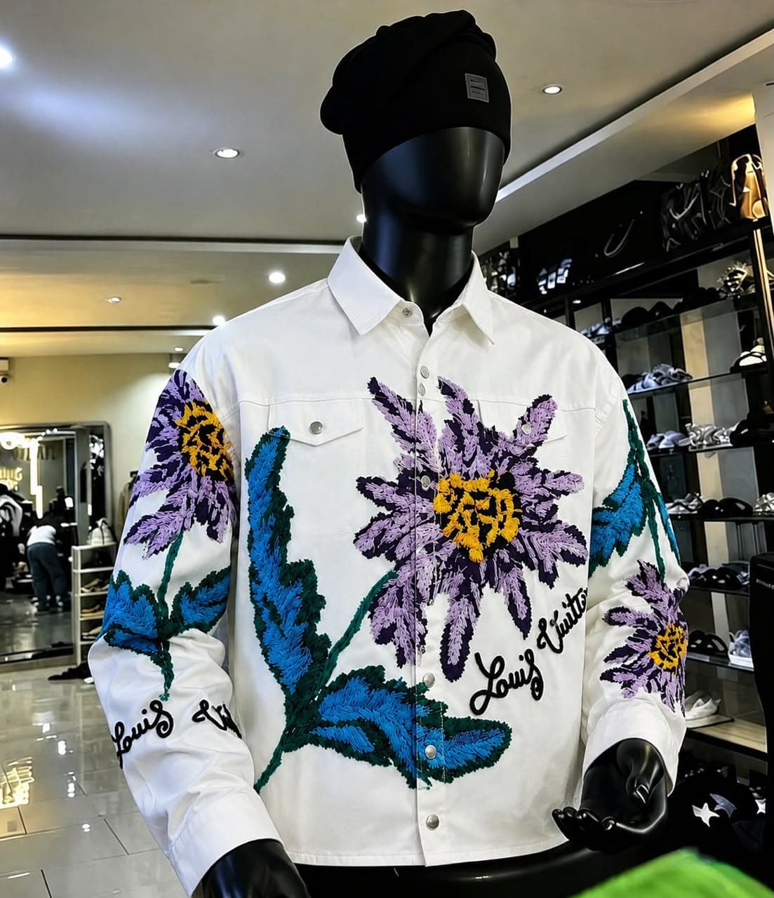 Front view of white floral embroidered Louis Vuitton jacket on mannequin.