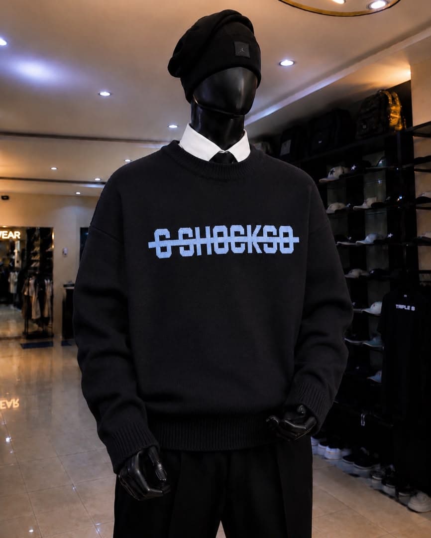 Mannequin wearing black sweatshirt with light blue pixel G-SHOCKSO graphic.