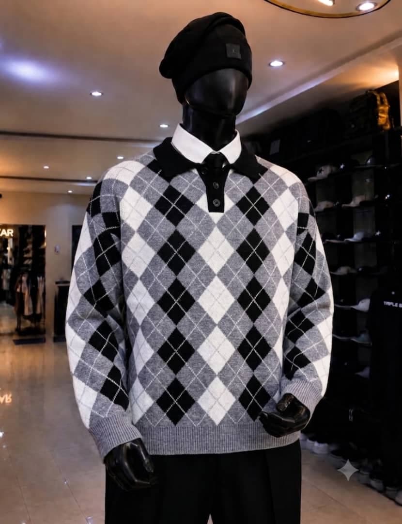 Mannequin wearing gray black and white argyle polo collar sweatshirt.