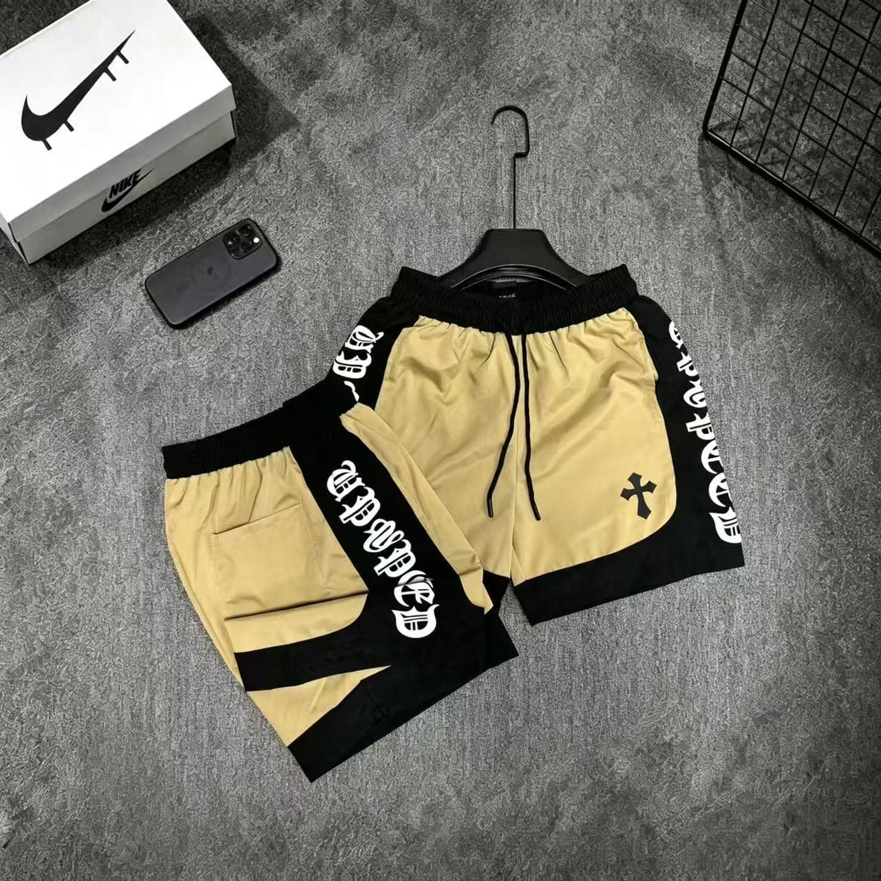 Yellow Chrome Hearts graphic shorts with black accents.